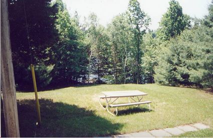 The lawn leading down to the double-slip boathouse