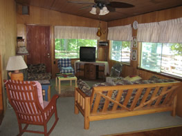 The living room features two comfortable futons, satellite TV & more.