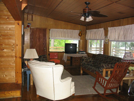 The living room features two comfortable futons, satellite TV & more.